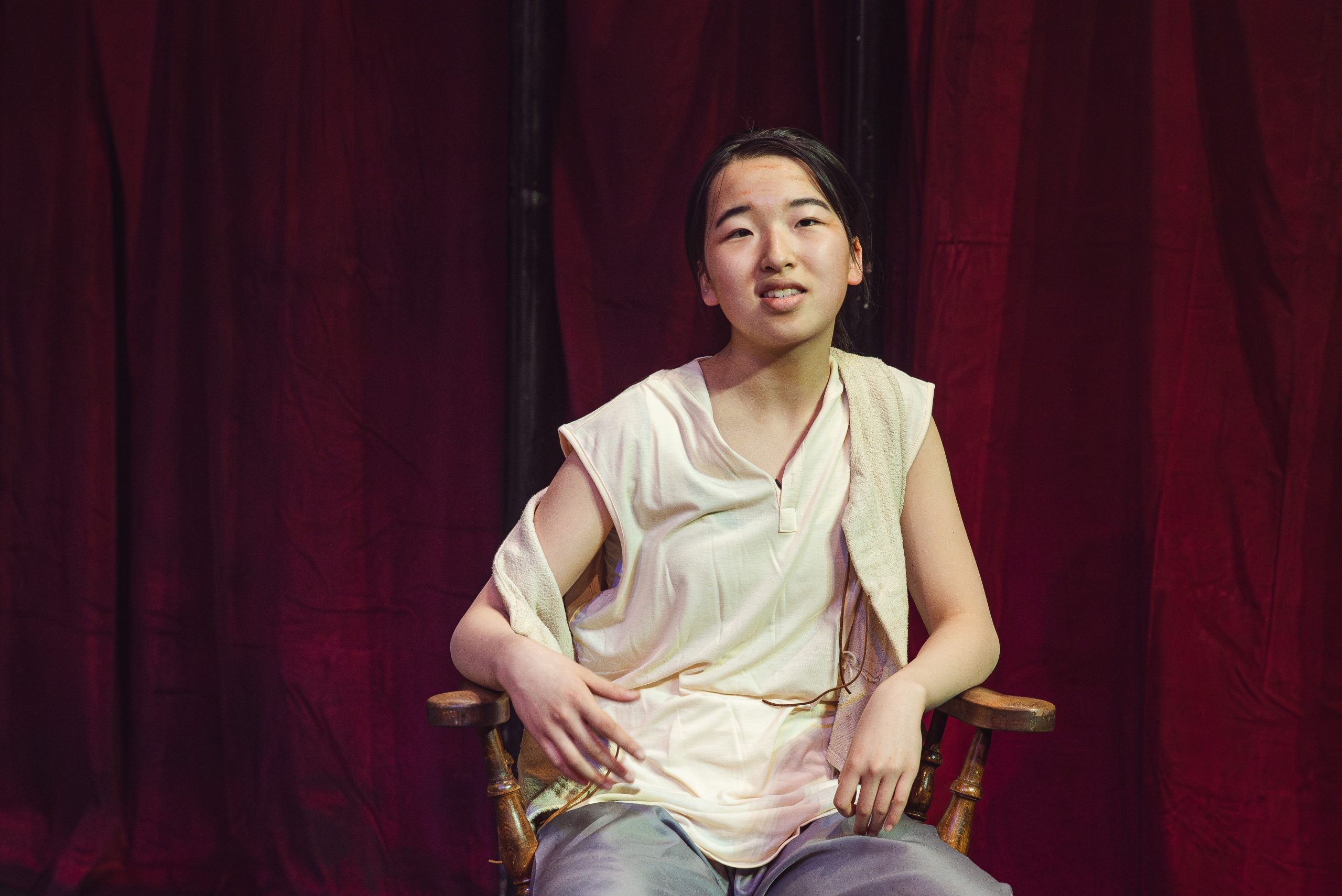 Girl sat in a chair on stage