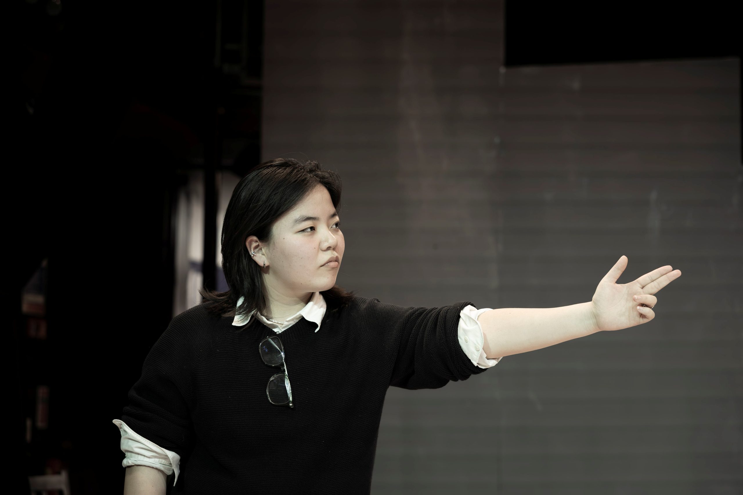 A girl rehearsing and pointing her finger at someone
