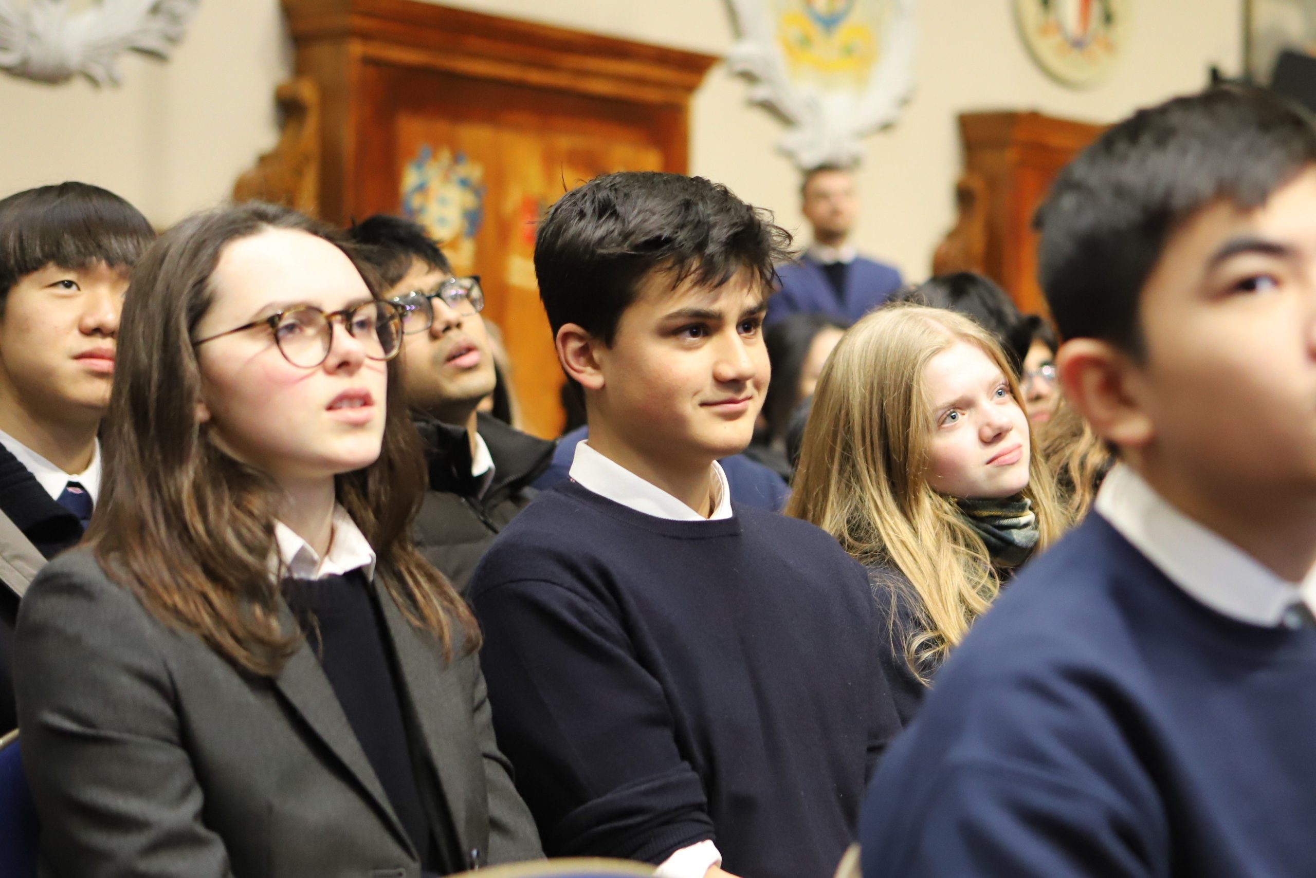 A boy and two girls in the audience at a Locke Lecture