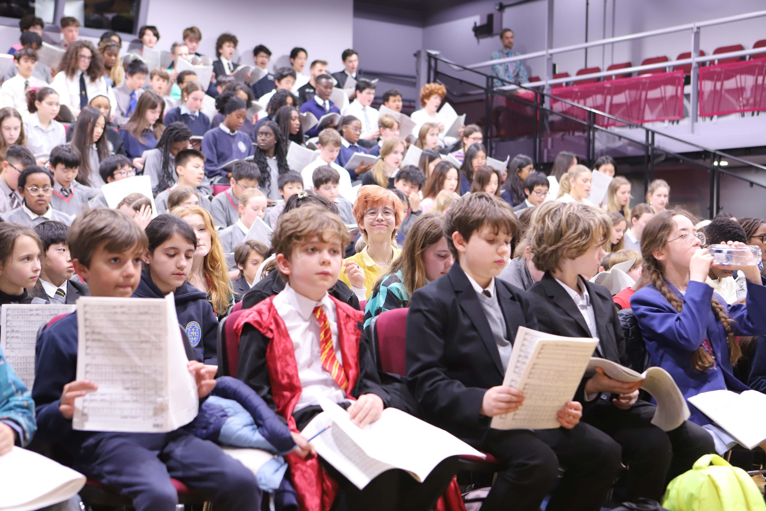 Pupils from Westminster and its partner schools singing in the Under School's theatre