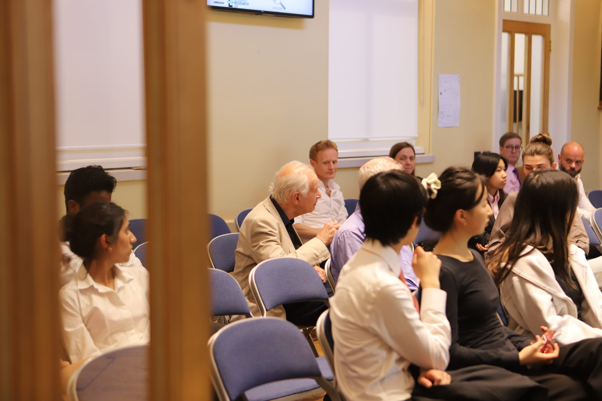 An elderly man asking a question in the audience.