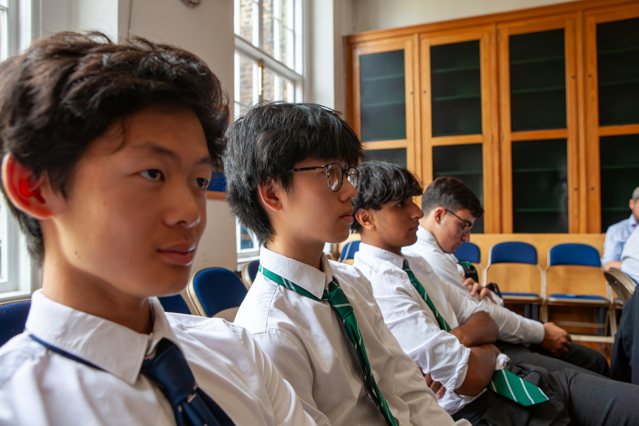 Four boys in the audience, in a row