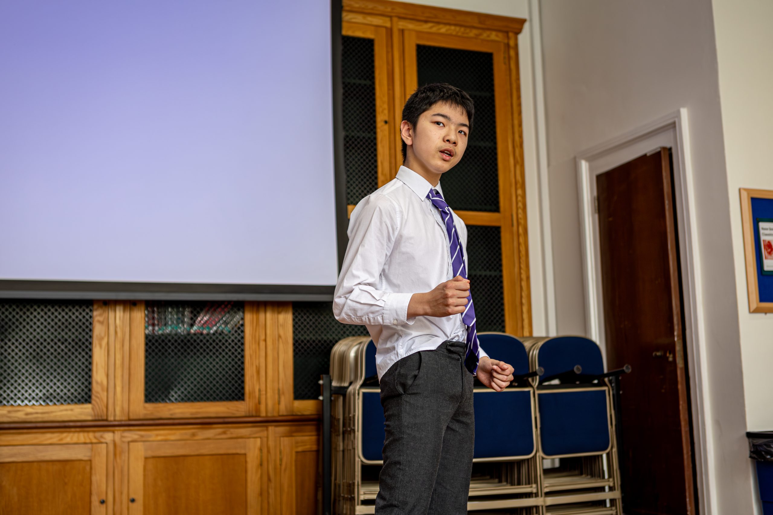 A speaker standing just in front of the screen