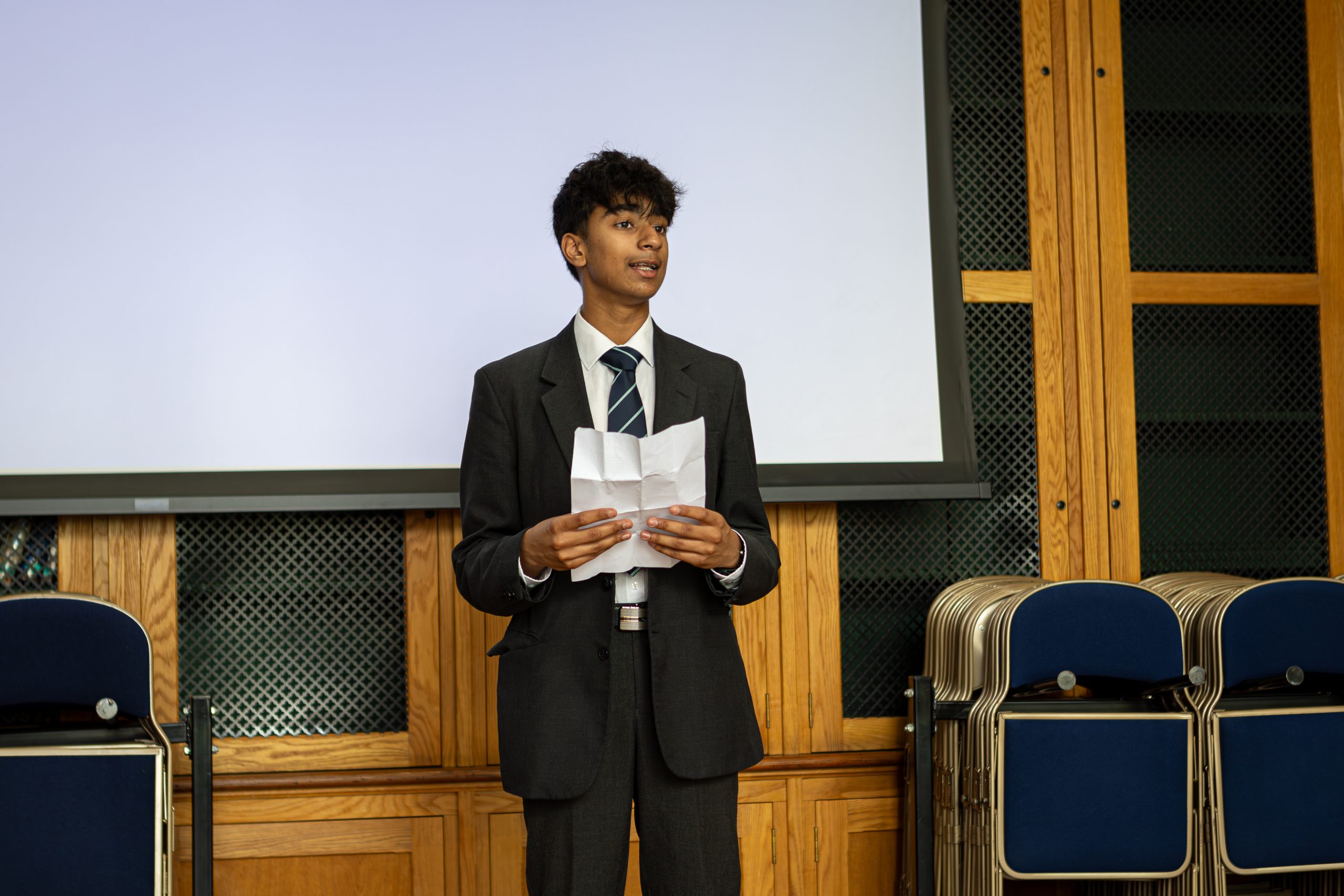 A speaker standing just in front of the screen