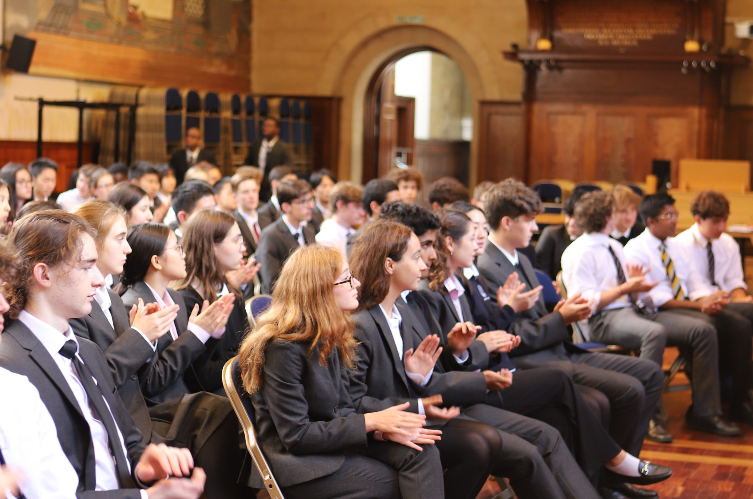 The front two rows of Sixth Form girls and boys sat down and applauding in the audience, after listening to Bijan Omrani speak on the themes of his new book 'God is an Englishman' at Westminster School.