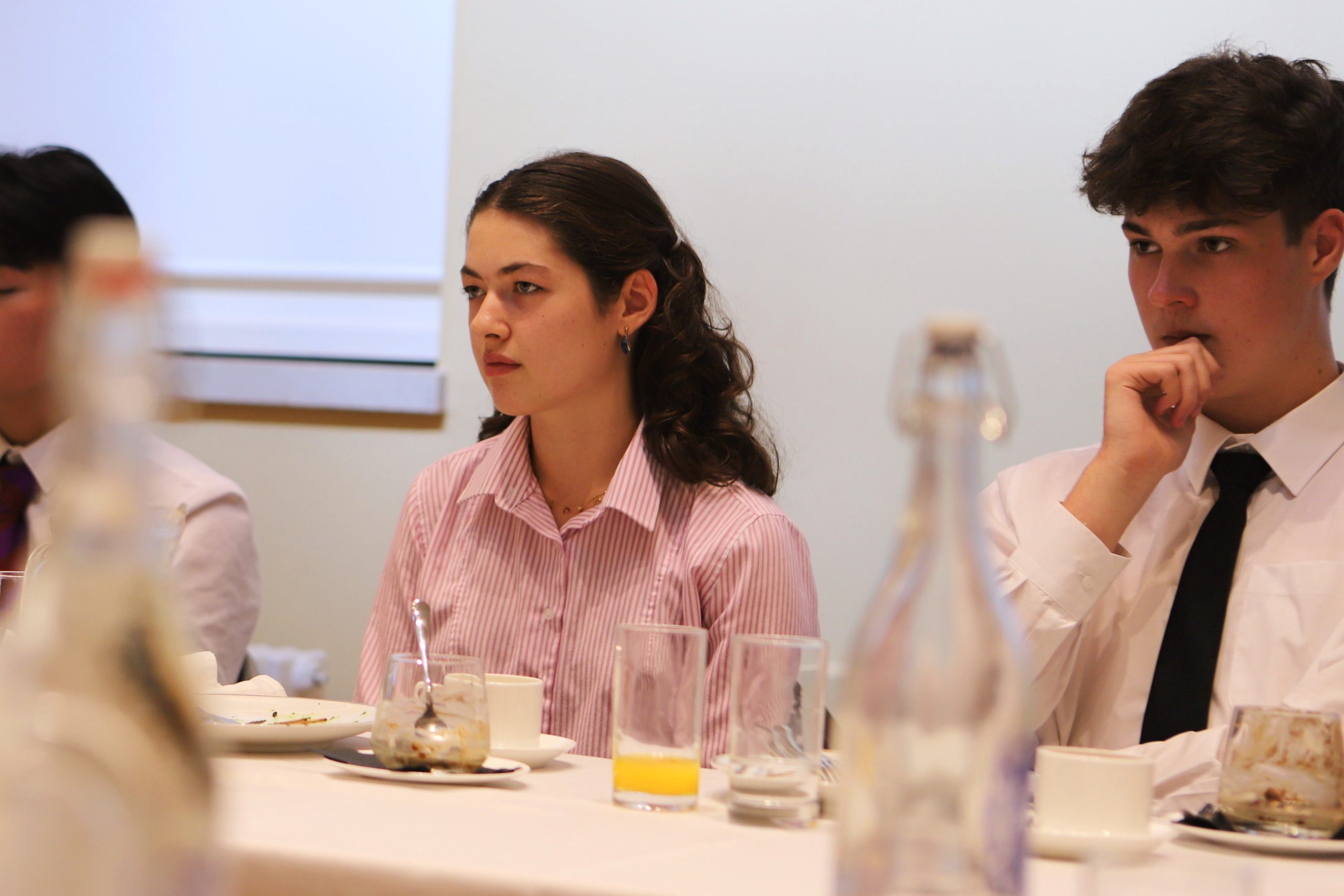 A girl and boy engaging in conversation with Bijan Omrani at the Locke Lunch, following Bijan's talk on his new book 'God is an Englishman' at Westminster School.
