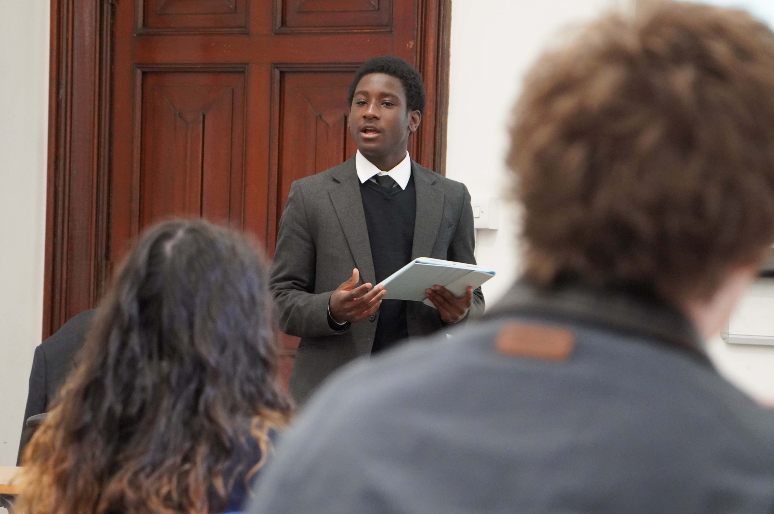 Sixth Form pupil speaking to other pupils in Linguistics Society for BHM