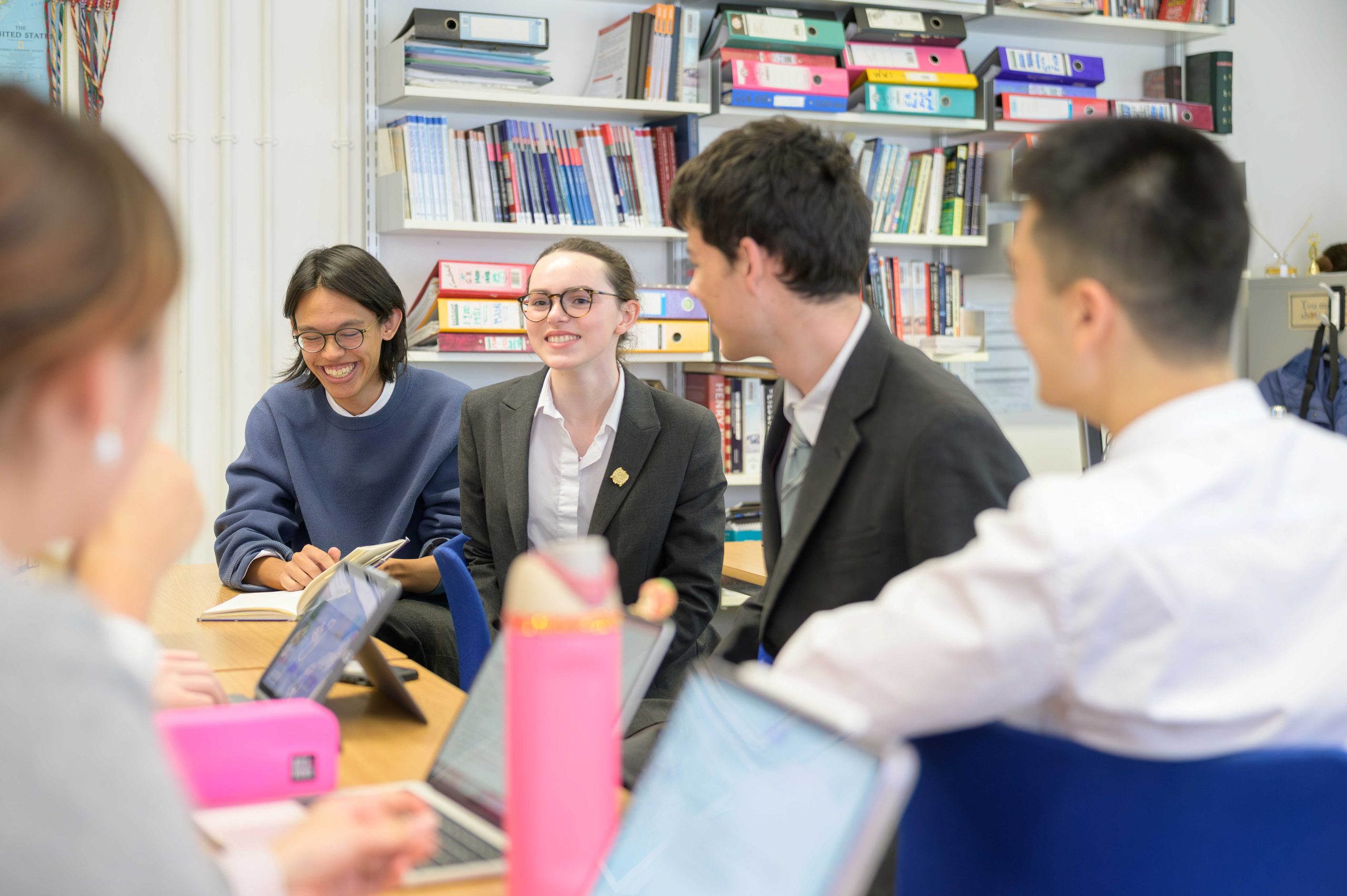 Four Year 13 pupils sat in class discussing History and smiling