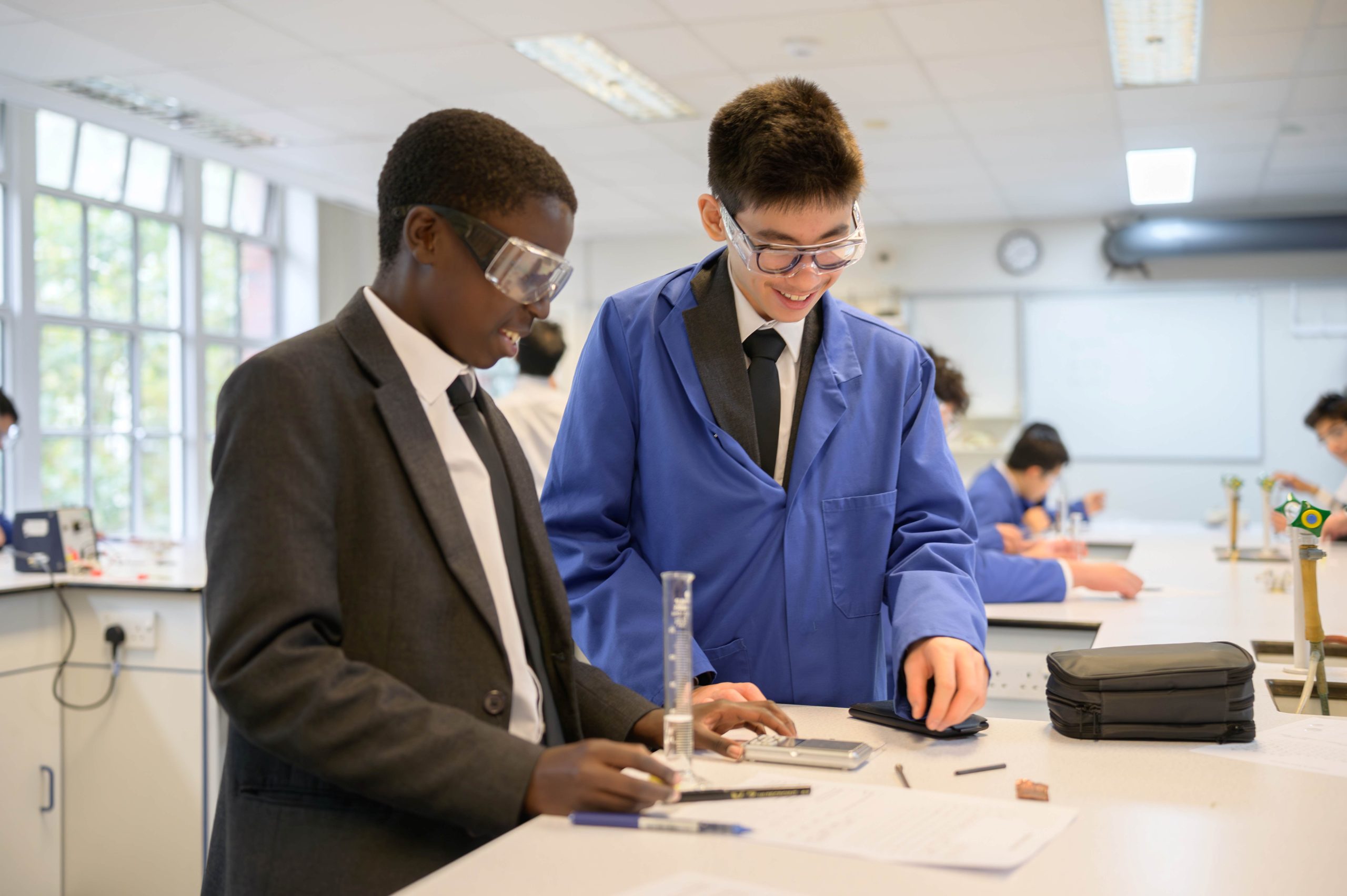 Two boys conducting a Chemistry practical in the lab