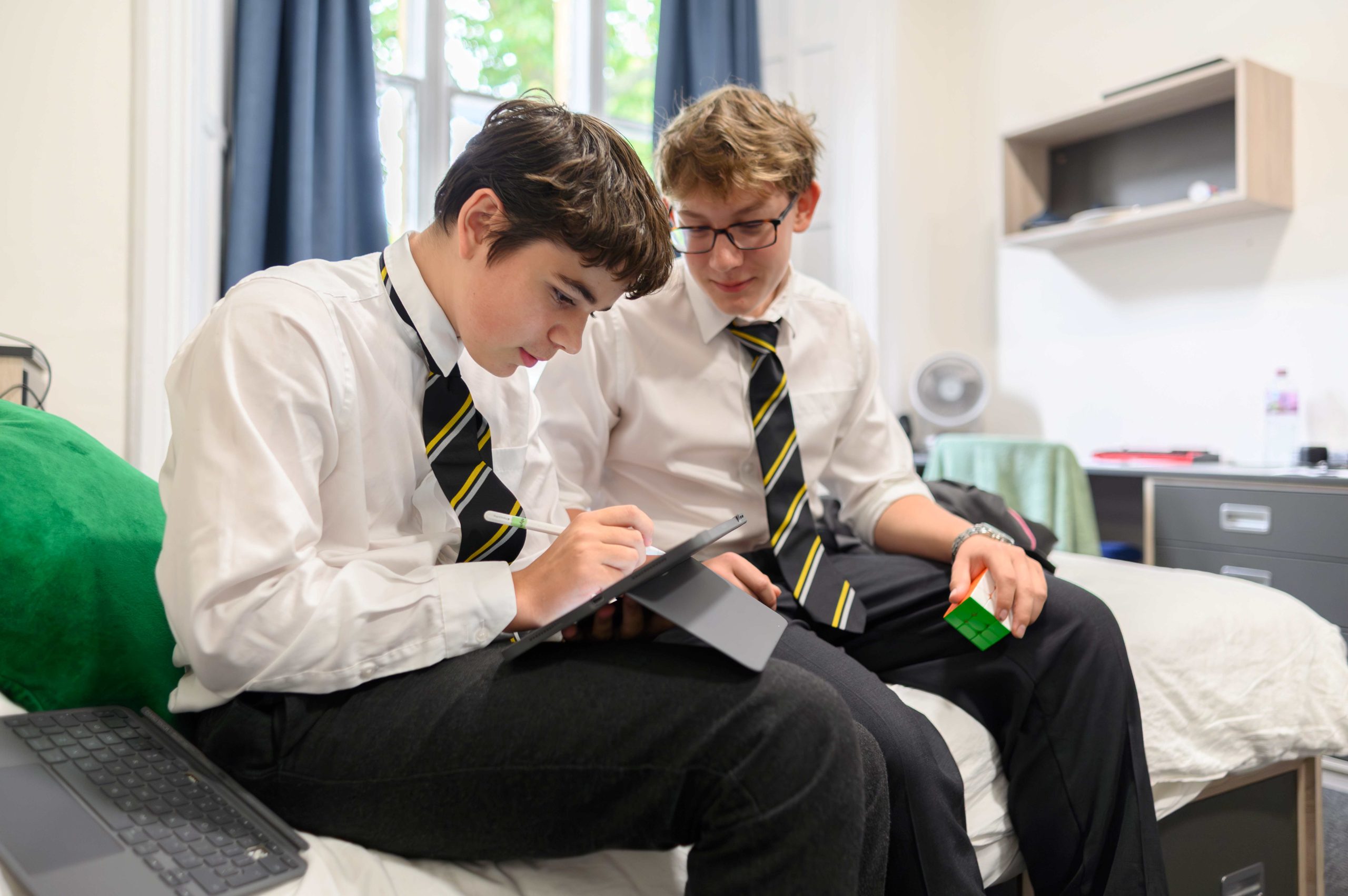 Two boys working together in their dorm
