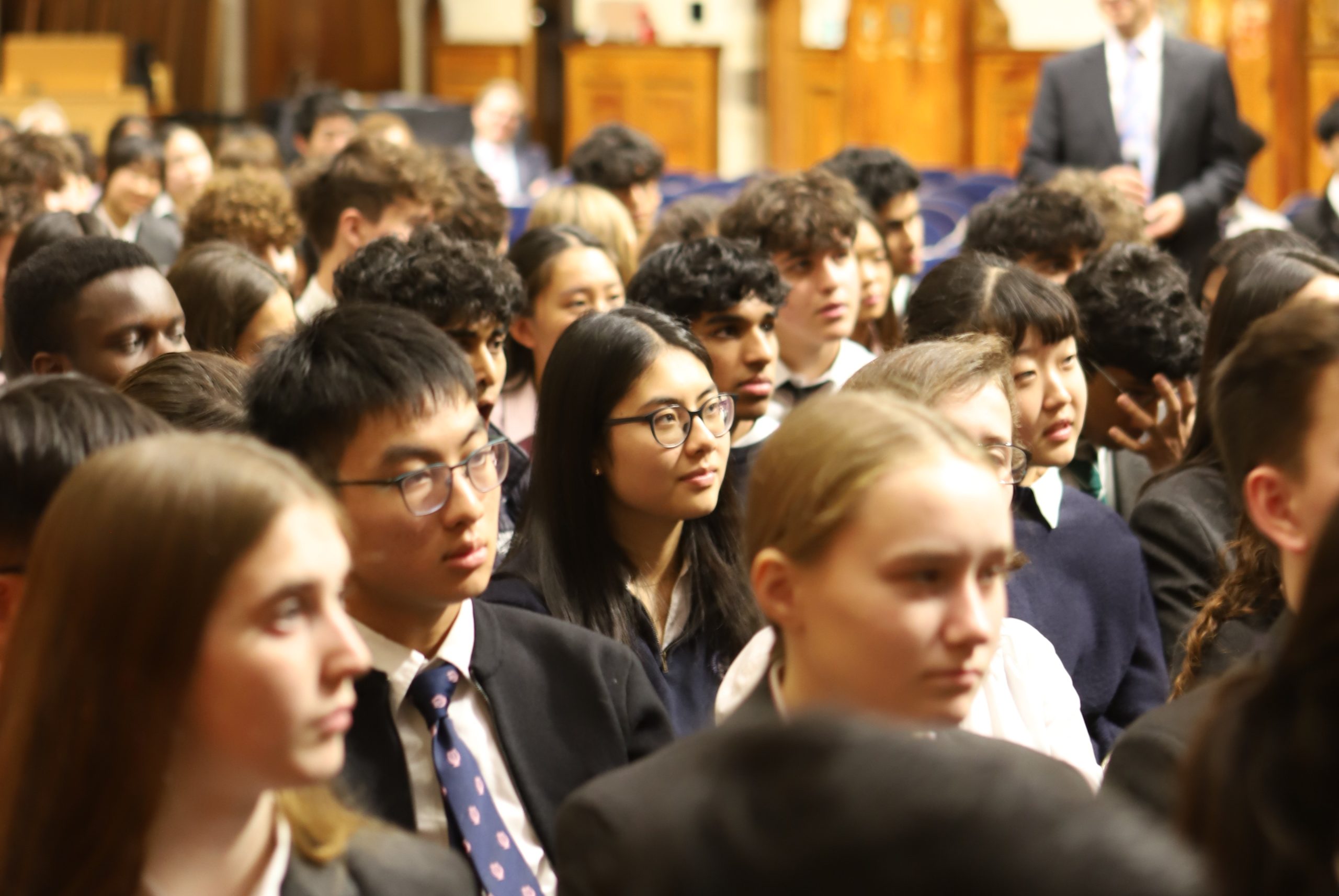 Girls and boys in the audience of Basi's Locke Lecture listening to the speaker