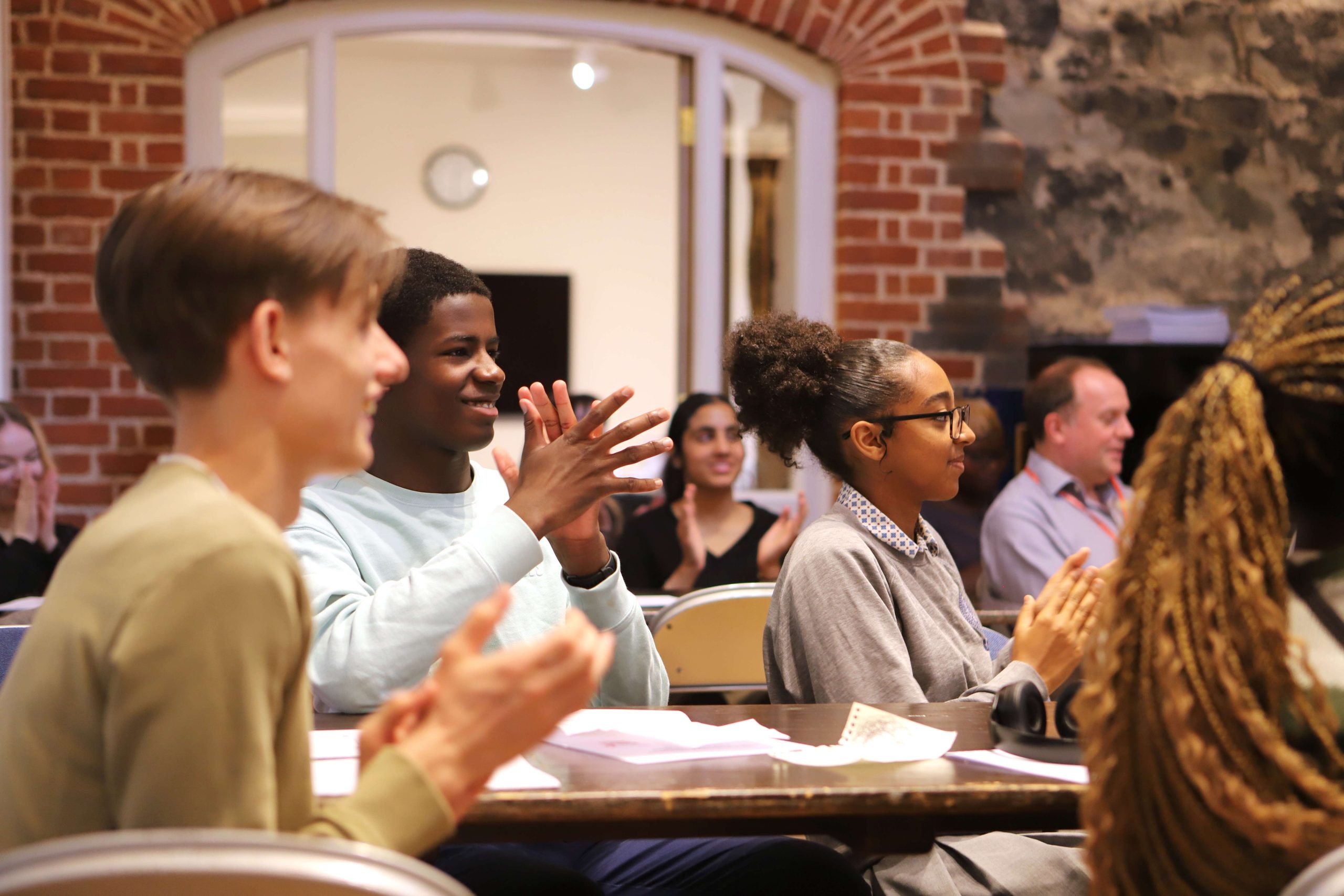 Platformers sat down at Westminster clapping the group who has just presented in front of them