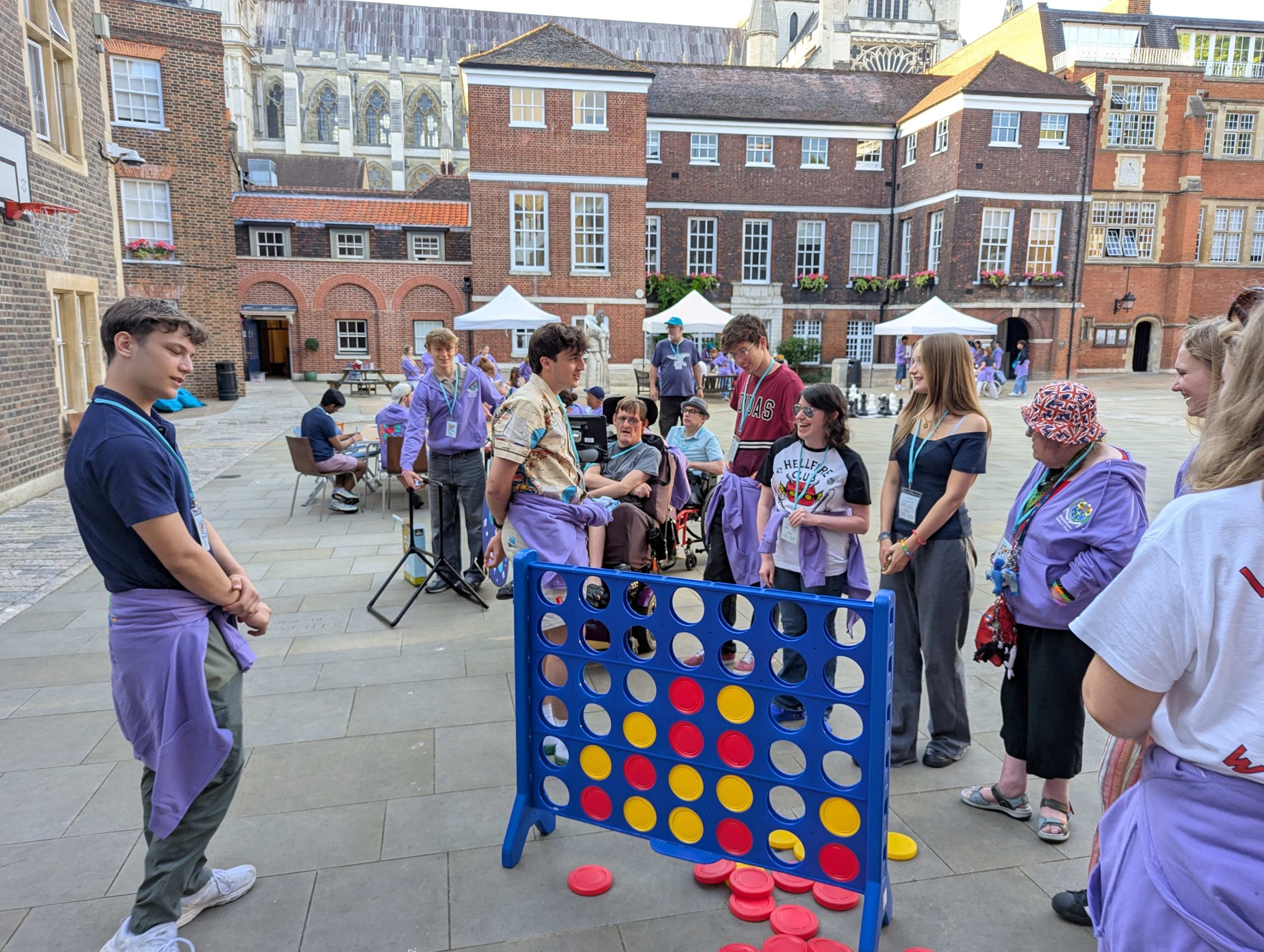 The Phab opening eve in Yard with guests arriving and meeting hosts, with School and the Abbey in the background