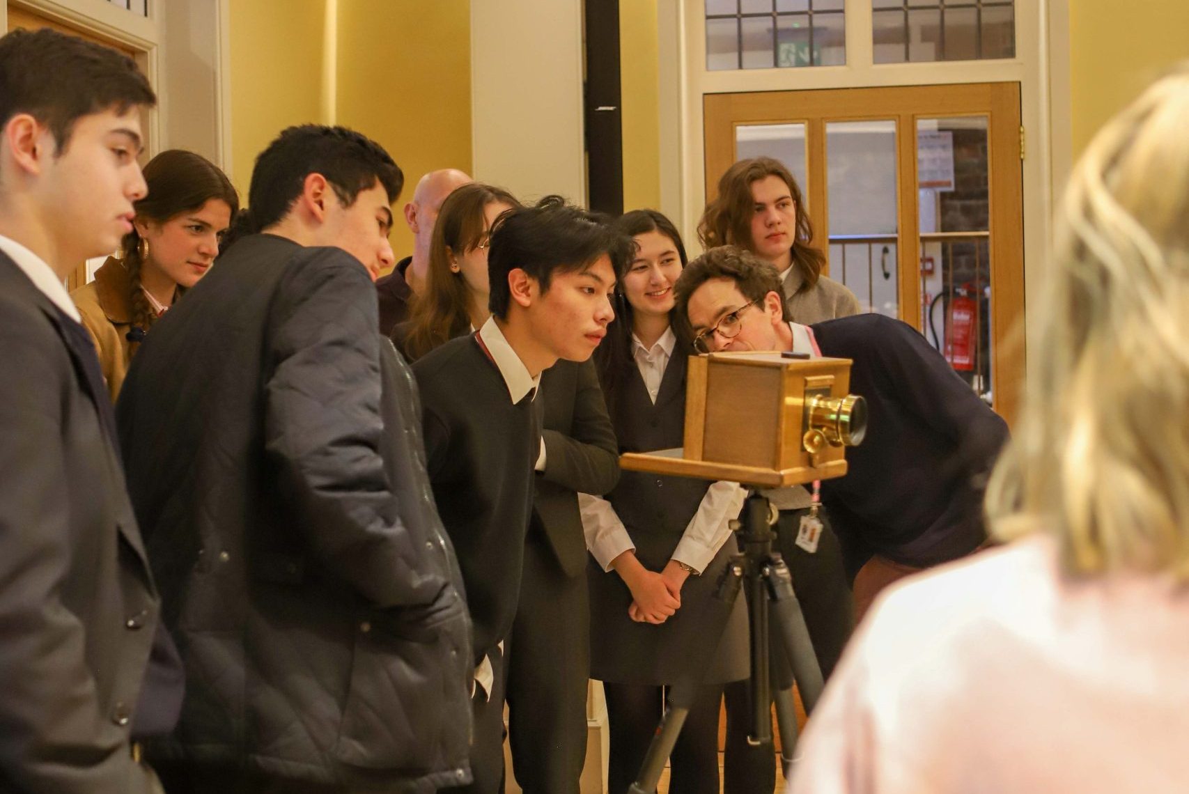 The group looking through the antique box camera