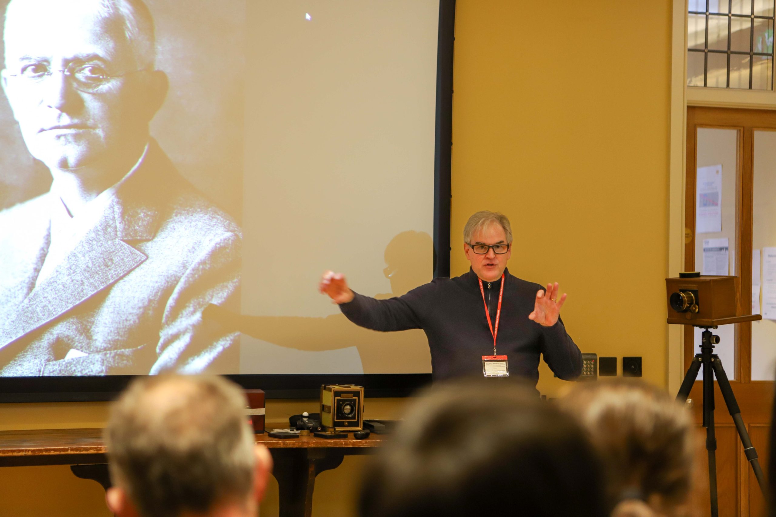 Pete Swann talking to his audience, in front of the screen