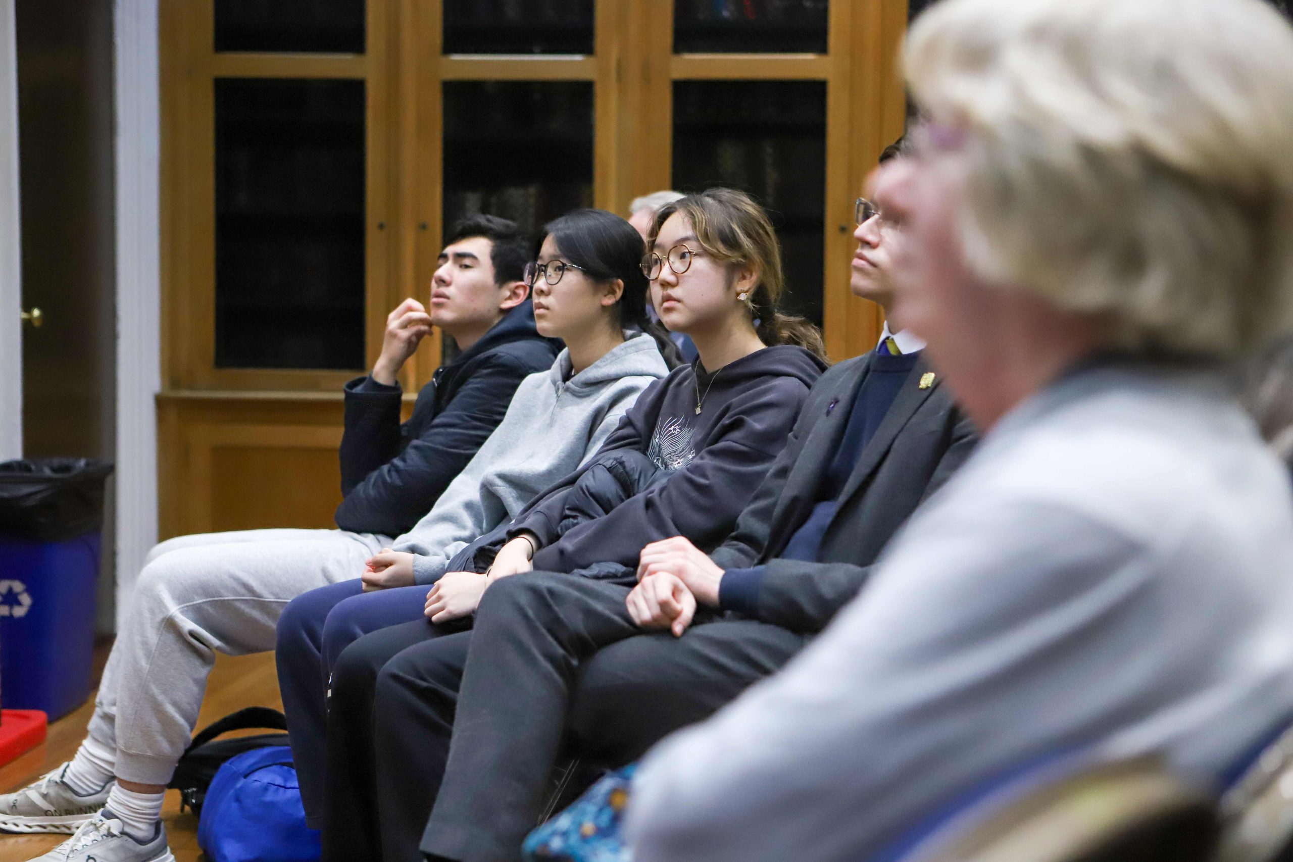 One boy and two girls in the audience listening to Professor Lockwood