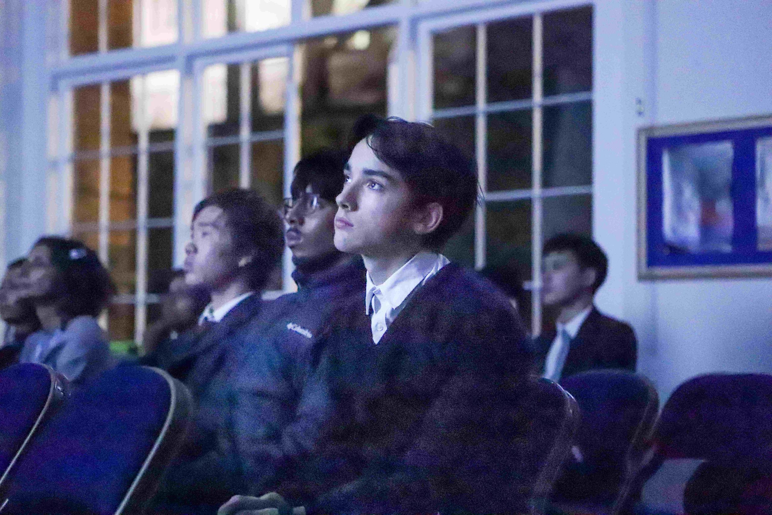 Boys watching the Professor Lockwood talk, lights off and lit up by the screen