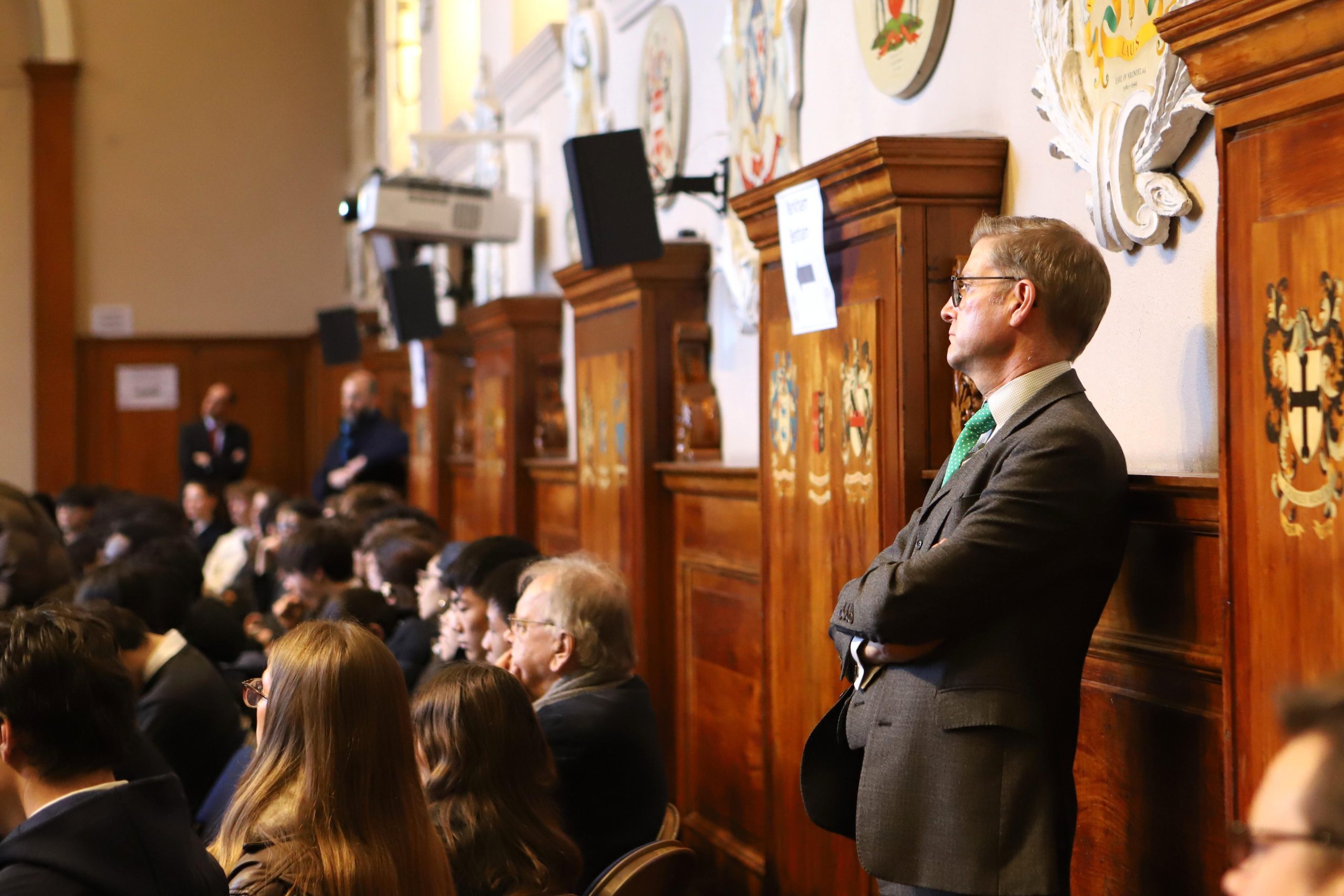 The Head Master standing at the back watching the talk