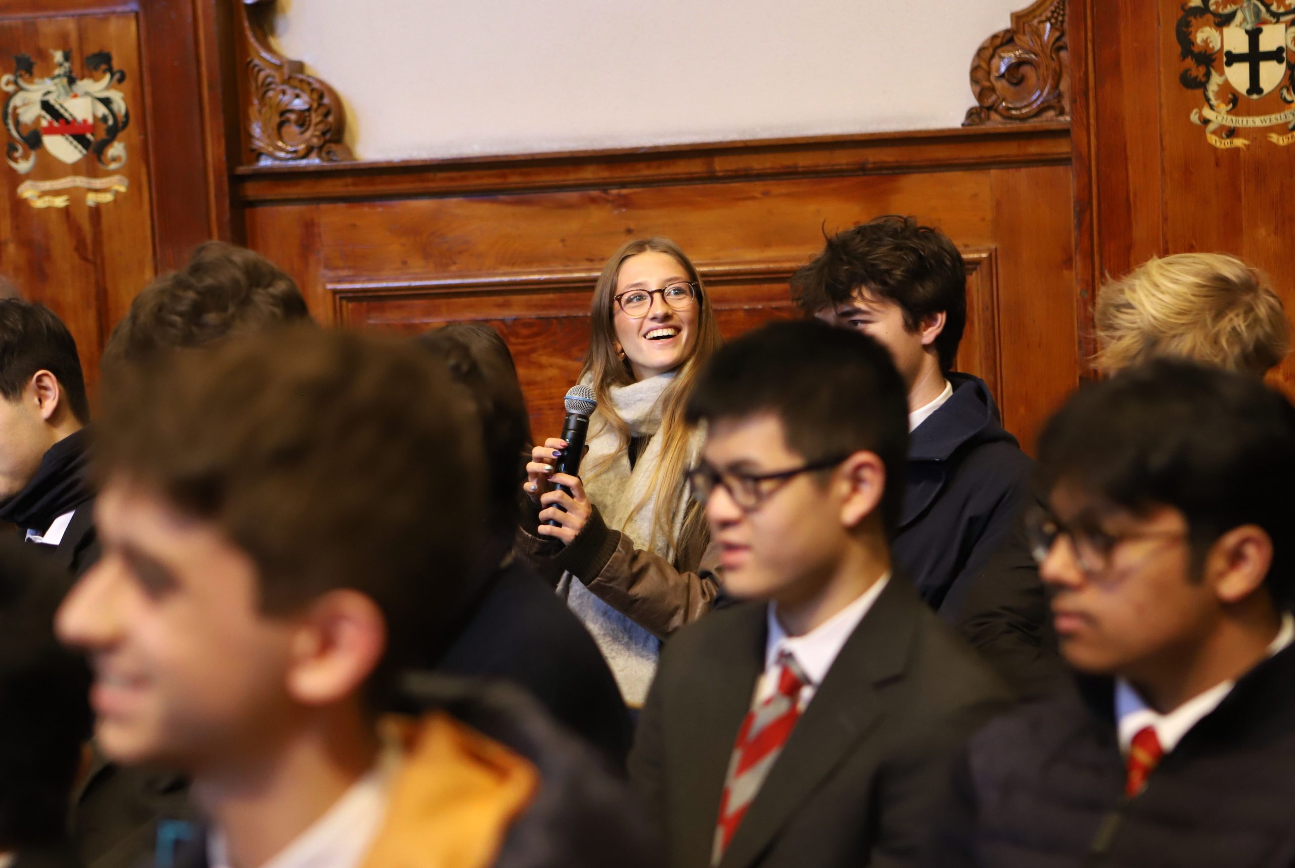 A Sixth Form girl asking a question, smiling