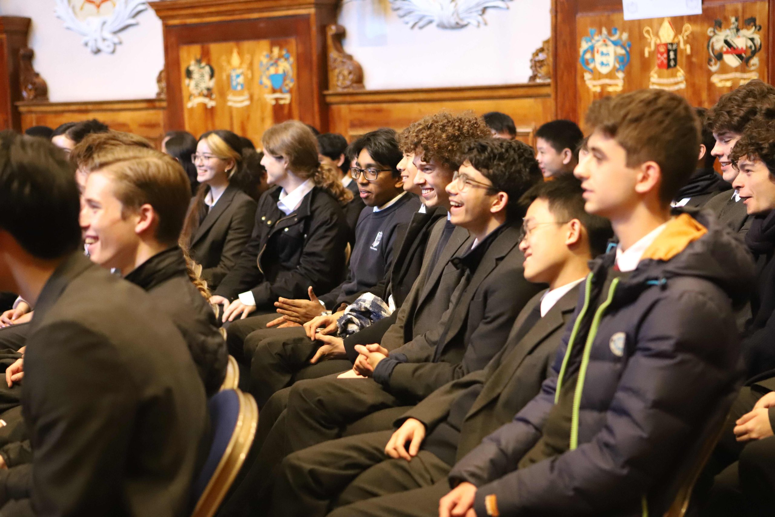 A row of pupils laughing at something the speaker said
