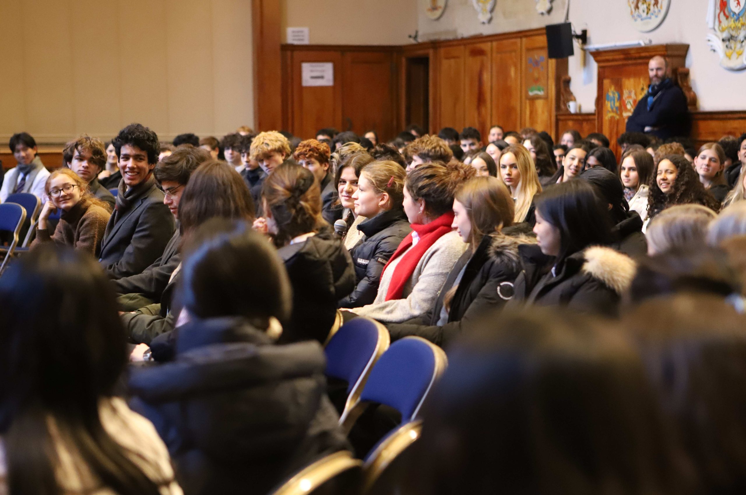 A Sixth Form girl asking a question in the centre of the audience
