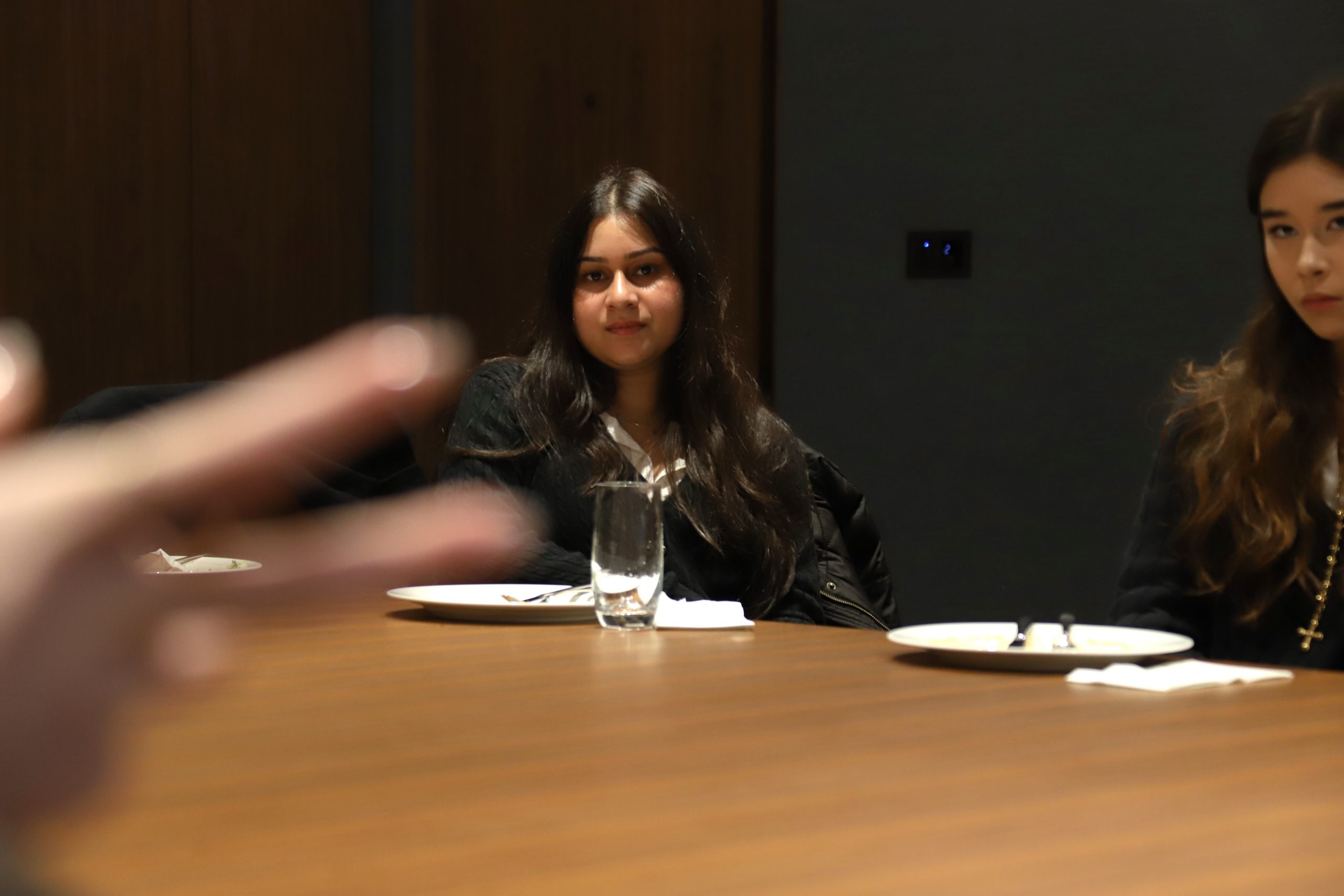 A girl listening to one of the Lazard speakers in the board room